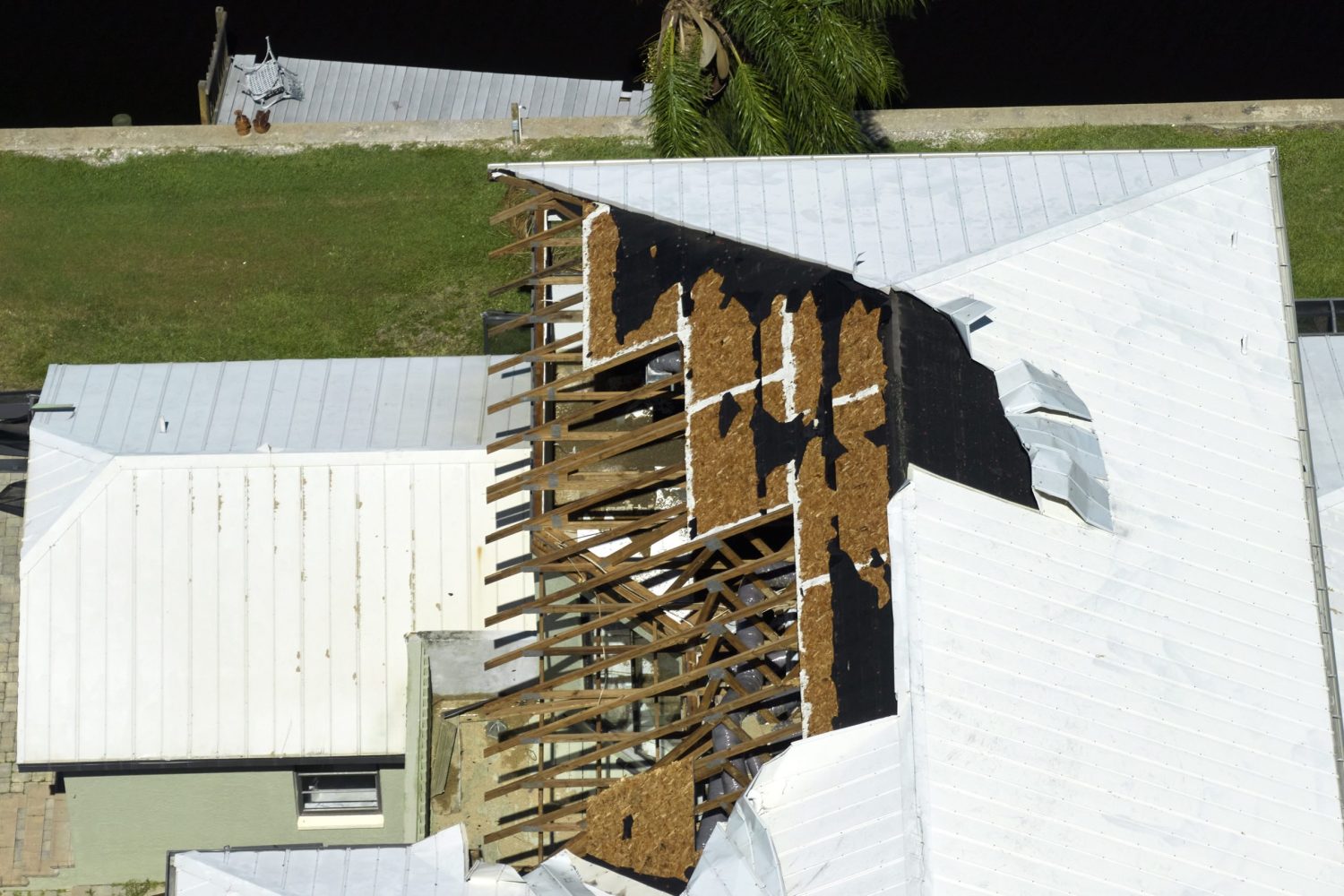 Hurricane Ian destroyed house roof in Florida residential area. Natural disaster and its consequences